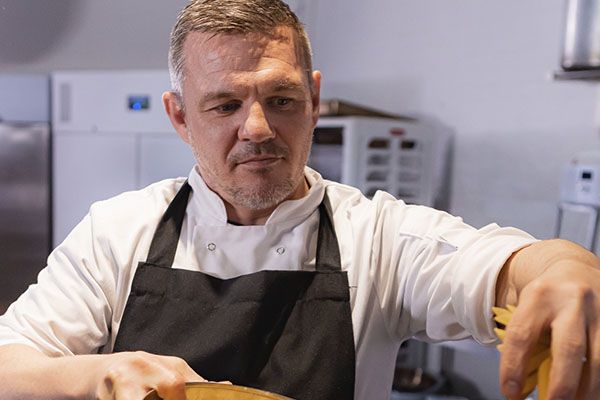 A chef frying food in a wok
