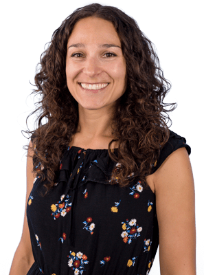 a friendly woman smiling, pictured from the waist up