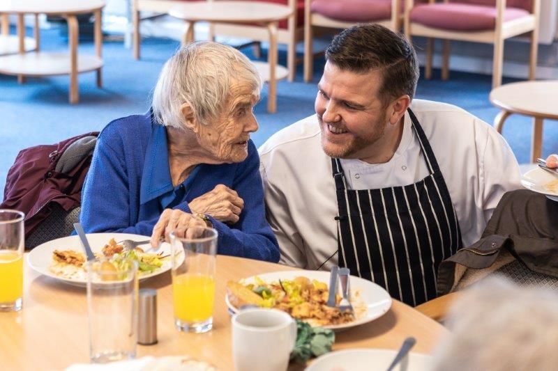 A chef frying food in a wok